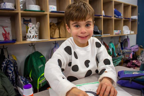 boy dressed as dalmatian dog smiling
